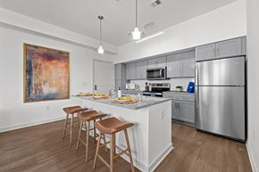 Aberdeen apartment for rent - a kitchen with stainless steel appliances and a counter with three stools