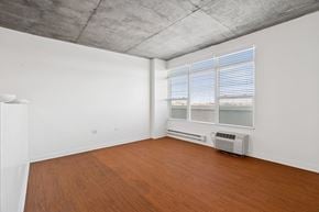 Denver apartment for rent - A room with a window and a wall-mounted air conditioner.