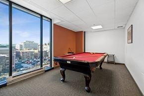 Denver apartment for rent - A pool table in a room with a view of the city.