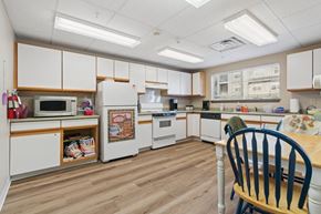 Broomfield apartment for rent - A kitchen with white cabinets and wooden floors.