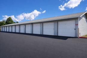 Layton apartment for rent - A long building with a grey roof and white garage doors.