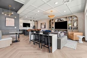 Denver apartment for rent - A modern living room with a grey sofa, a wooden floor, and a white ceiling.