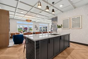 Denver apartment for rent - A modern kitchen with a large island and a view of the outdoors.
