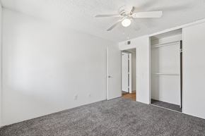 Tucson apartment for rent - Casa Bella bedroom with white walls, carpet and ceiling fan
