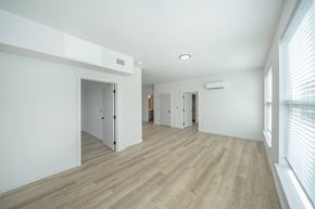 Liberty Lake apartment for rent - A spacious room with wooden flooring and white walls.