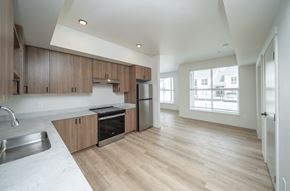 Liberty Lake apartment for rent - A kitchen with wooden cabinets and a white counter top.