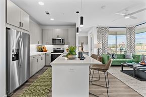Colorado Springs apartment for rent - an open kitchen and living room with a stainless steel refrigerator
