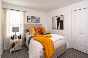 Babcock Ranch apartment for rent - a room with striped wallpaper and a bed with a yellow blanket