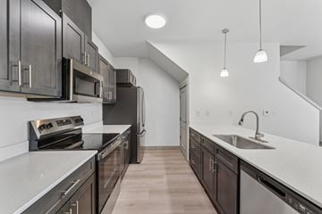 Salem apartment for rent - A modern kitchen with dark wood cabinets and stainless steel appliances.