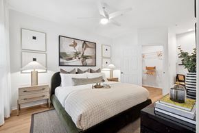 Richardson apartment for rent - A bedroom with a large bed and a ceiling fan.