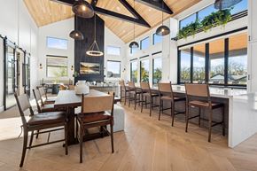 Melissa apartment for rent - A modern dining room with wooden floors and furniture.