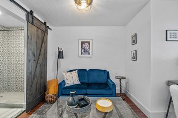 Boise apartment for rent - a living room with a blue couch and a sliding barn door