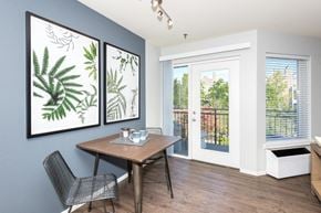 Portland apartment for rent - a dining room with a table and chairs and a door to a balcony
