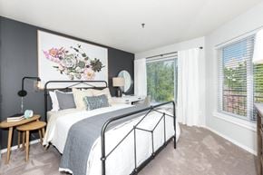 Portland apartment for rent - a bedroom with a bed and two windows