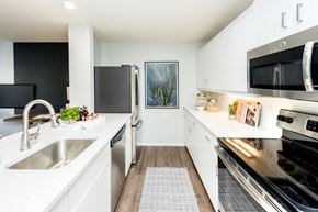 Portland apartment for rent - a white kitchen with stainless steel appliances and a sink