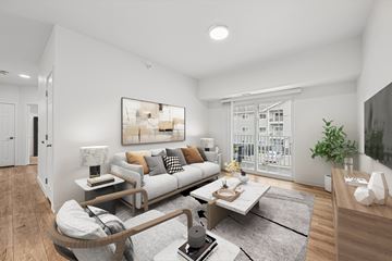 Gillette apartment for rent - A modern living room with a grey sofa, a coffee table, and a large painting on the wall.