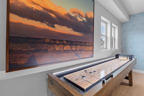 Layton apartment for rent - a game room with a large screen tv and a shuffleboard table