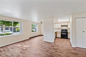 Corvallis apartment for rent - A room with a wood floor and a wall-mounted TV.