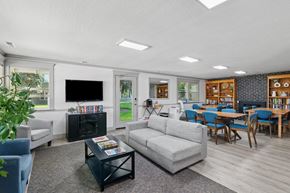 Eugene apartment for rent - A living room with a grey couch, a black coffee table, and a television.