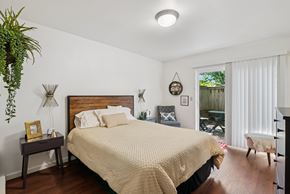 Springfield apartment for rent - A bedroom with a large bed and a wooden headboard.