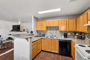 Springfield apartment for rent - A kitchen with wooden cabinets and black appliances.