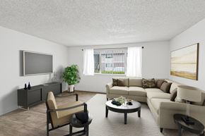 Springfield apartment for rent - A living room with a grey sofa, a brown armchair, a coffee table, and a flat screen TV mounted on the wall.