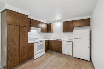 Springfield apartment for rent - A kitchen with white appliances and wooden cabinets.