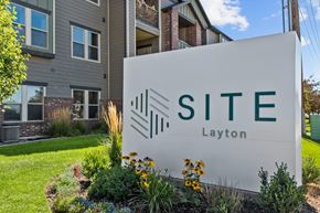 Layton apartment for rent - a sign that says site layton in front of a building