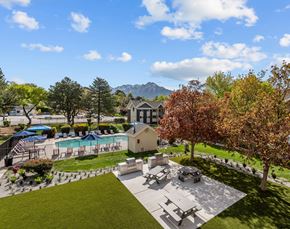 Salt Lake City apartment for rent - A backyard with a picnic table, a pool, and a mountain in the background.