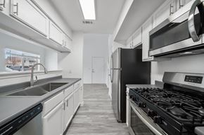 Gillette apartment for rent - a kitchen with white cabinets and stainless steel appliances
