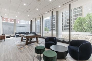 Baltimore apartment for rent - A modern living room with a long table and black chairs.