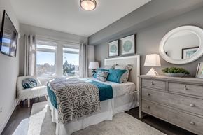Bellevue apartment for rent - Lux Apartments Bellevue spacious bedroom with large windows, a queen-sized bed, side table and dresser with extra room to walk around the bed