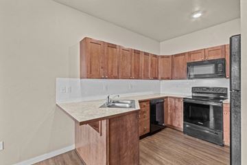 Spokane apartment for rent - a kitchen with wooden cabinets and a sink