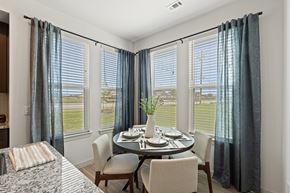 Pflugerville apartment for rent - A dining room with a table set for two and a view of the outdoors.
