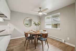 Gresham apartment for rent - A dining room with a round mirror and a table set for four.