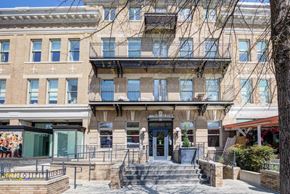 Washington apartment for rent - A building with a black awning and a glass door.