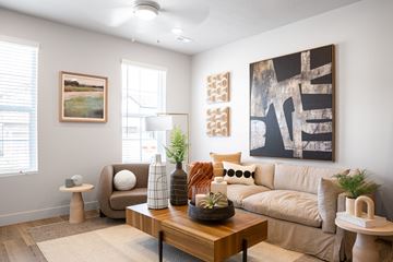 Lehi apartment for rent - A living room with a couch, a coffee table, and a painting on the wall.