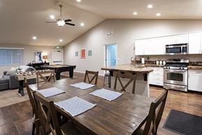 Spokane Valley apartment for rent - A modern dining room with a large wooden table and chairs.