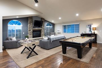 Spokane Valley apartment for rent - A pool table is in the middle of a living room.