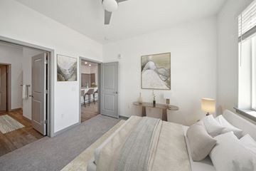 Denver apartment for rent - A bedroom with a large bed and a painting on the wall.