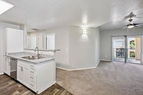 Tucson apartment for rent - A kitchen with white cabinets and a sink.