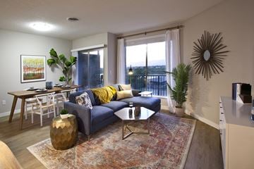 Richland apartment for rent - a living room with a blue couch and a dining room table