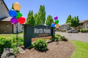Corvallis apartment for rent - a sign that says north point apartments with balloons in front of it