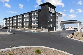 Kennewick apartment for rent - a large black building with a parking lot in front of it