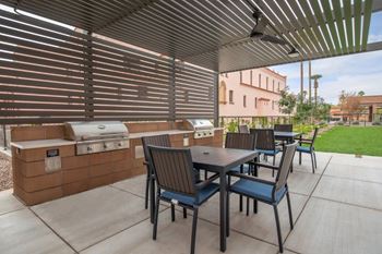 Fenced pool with lagoon, hot tub, bbq area with bar seating, lounge seating, fire pits, ramadas, water curtain feature, and pool house