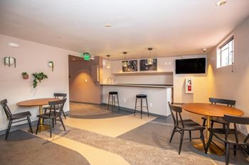 Community bar with kitchenette, bar seating and personal booth