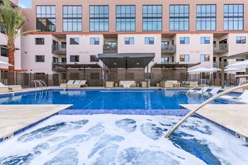 Fenced pool with lagoon, hot tub, bbq area with bar seating, lounge seating, fire pits, ramadas, water curtain feature, and pool house