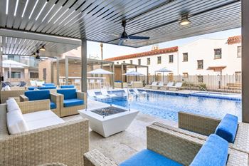Fenced pool with lagoon, hot tub, bbq area with bar seating, lounge seating, fire pits, ramadas, water curtain feature, and pool house