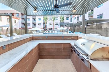 Fenced pool with lagoon, hot tub, bbq area with bar seating, lounge seating, fire pits, ramadas, water curtain feature, and pool house