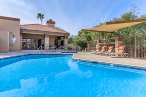 Tucson apartment for rent - A swimming pool with a sun lounger and a building in the background.